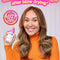 Woman with styled hair holding a bottle of K-8 hair product, with text about heat protection and breakage reduction.